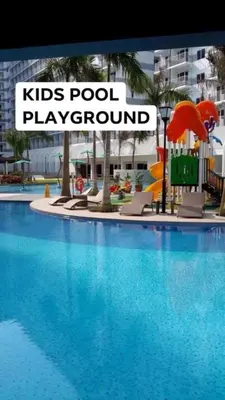 a large swimming pool with a kids pool play ground at SHORE RESIDENCE d6, shortwalk Mall of Asia near Airport in Manila