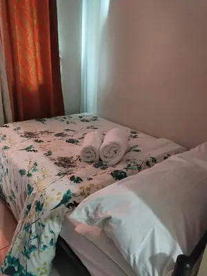 a bedroom with a bed with towels on it at Moa's Spot at Sea Residences in Manila