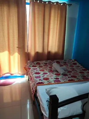 a small bedroom with a bed and a window at Moa's Spot at Sea Residences in Manila