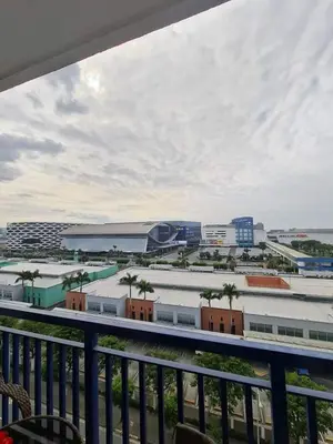 a view of a city with palm trees and buildings at Moa's Spot at Sea Residences in Manila