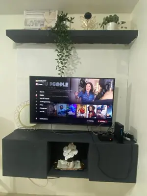 a flat screen tv sitting on top of a desk at Your Crib - kasara -19 D tower 1 in Manila