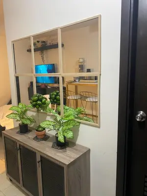 a cabinet with potted plants on top of it at Your Crib - kasara -19 D tower 1 in Manila