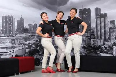 three women are posing for a picture in front of a city at Red Planet Ortigas in Manila