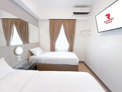 a hotel room with two beds and a window at Red Planet Ortigas in Manila