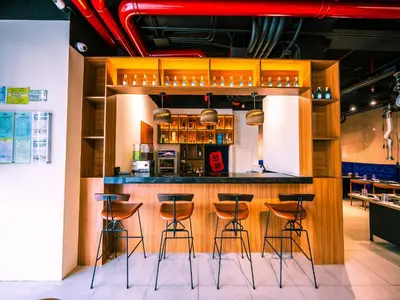 a bar in a restaurant with stools at Red Planet Ortigas in Manila
