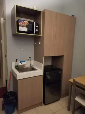 a small kitchen with a sink and a microwave at Mack's Awesome Place 11 with Netflix and FastUnliwifi in Manila