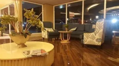 a living room with a couch and a table at SHELL RESIDENCE c5, shortwalk MALL OF ASIA near Airport in Manila
