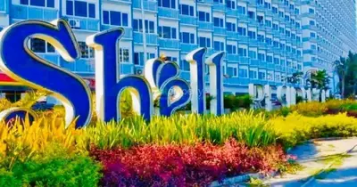 a sign in front of a large building at SHELL RESIDENCE c4 shortwalk Mall of Asia near airport in Manila