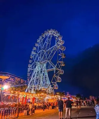 a large ferris wheel at a carnival at night at SHELL RESIDENCE c4 shortwalk Mall of Asia near airport in Manila