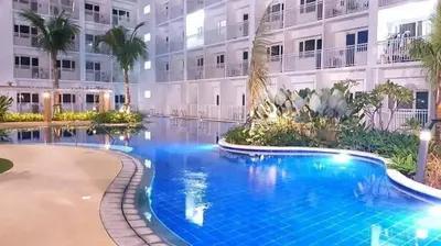 a large swimming pool in front of a building at SHELL RESIDENCE c4 shortwalk Mall of Asia near airport in Manila