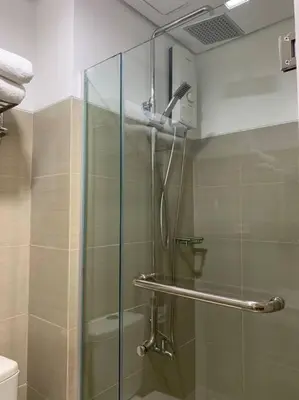 a shower with a glass door in a bathroom at Cozy Space at Shore Residences in Tower D in Manila
