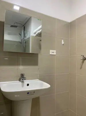 a bathroom with a sink and a mirror at Cozy Space at Shore Residences in Tower D in Manila