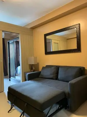 a living room with a couch and a mirror at Cozy Space at Shore Residences in Tower D in Manila