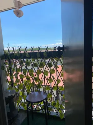 a view from a balcony with a table and a chair at Cozy Boo Bed and Breakfast near Enchanted Kingdom by Dynel in Santa Rosa