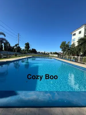a large blue swimming pool with the words cozy boo at Cozy Boo Bed and Breakfast near Enchanted Kingdom by Dynel in Santa Rosa