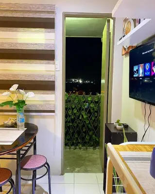 a dining room with a view of a balcony at Cozy Boo Bed and Breakfast near Enchanted Kingdom by Dynel in Santa Rosa