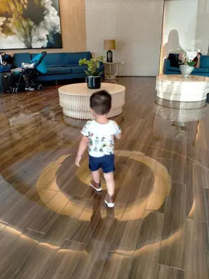 a young child walking in a living room at SHELL RESIDENCE c3 shortwalk mall of asia near airport in Manila