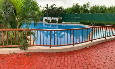 a swimming pool with a fence around it at At Home Condo With Free Pool Access in Manila