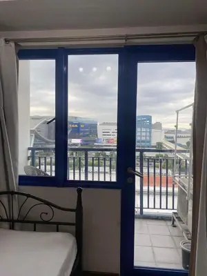 a room with a window with a view of a city at Madison's Place at Sea MOA in Manila