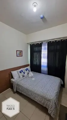 a bedroom with two beds with blue pillows at Mack's Awesome 15 with Netflix and FastUnliwifi in Manila