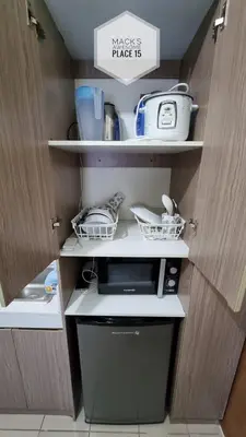 a kitchen with white shelves and a appliance in it at Mack's Awesome 15 with Netflix and FastUnliwifi in Manila