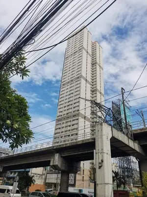 a tall building with a bridge in front of it at Mack's Awesome 15 with Netflix and FastUnliwifi in Manila