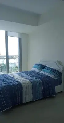 a bed in a white room with a window at AZURE URBAN RESORT - PARANAQUE MANILA NEAR TERMINAL UNLIMITED WIFI and Netflix in Manila