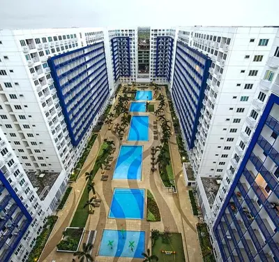 an aerial view of a city with tall buildings at Sea Residences MOA arena SMX by darpm in Manila