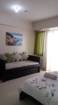 a bedroom with a bed and a window at One Palm Tree Villas NAIA TERMINAL 3 in Manila