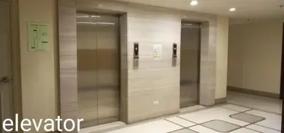 a elevator lobby with two elevators in a building at One Palm Tree Villas NAIA TERMINAL 3 in Manila