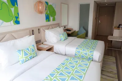 a hotel room with two beds and a room at Lime Resort Manila in Manila