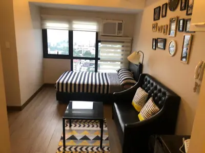 a living room with a couch and a table at The Sentinel Residences in Manila