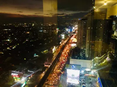 a city at night with a lot of traffic at The Sentinel Residences in Manila