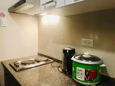 a kitchen counter with a coffee pot on a counter top at The Sentinel Residences in Manila