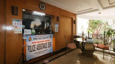 a room with a table and a sign on the wall at Casa Micarosa Hotel and Residences by RedDoorz in Manila