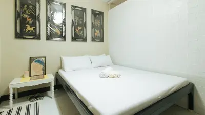 a bed in a room with two balls on it at JBs Transient House in General Trias