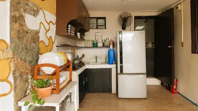 a kitchen with a white refrigerator in a room at JBs Transient House in General Trias