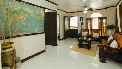 a living room with a large map on the wall at JBs Transient House in General Trias