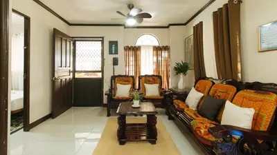 a living room with a couch and a table at JBs Transient House in General Trias