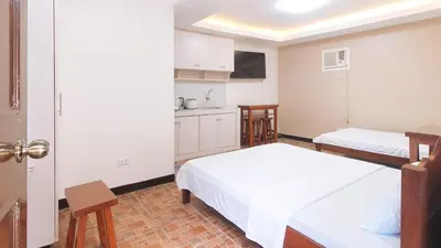 a small room with two beds and a kitchen at Alamaris Resort RedPartner in Rizal