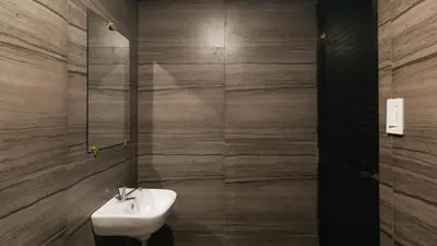 a bathroom with a sink and a mirror at Alamaris Resort RedPartner in Rizal