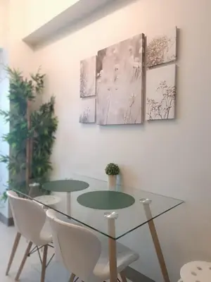 a dining room with a glass table and chairs at SMDC Coast Residences near PICC World Trade Center MOA in Manila