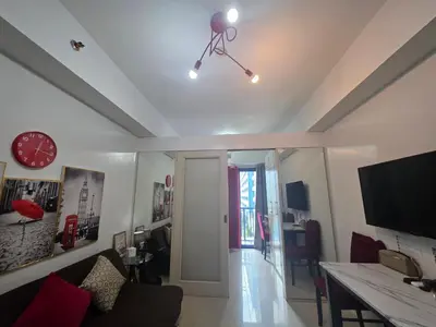 a living room with a camera on the ceiling at Sea Residences TowerE-F by EZStays in Manila