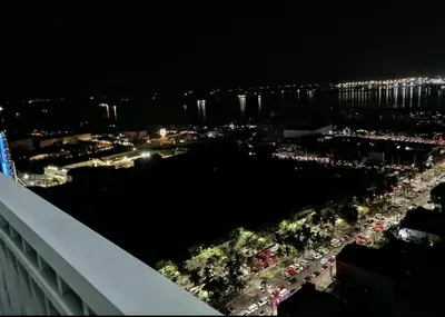 a view of a city at night with cars at BayBreeze Haven Nest in Manila
