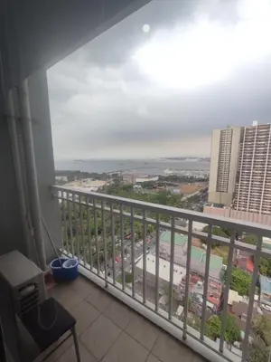 a balcony with a view of the ocean at BayBreeze Haven Nest in Manila