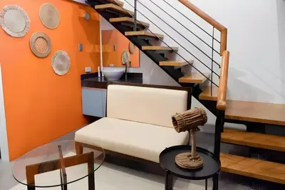 a room with a chair and a sink and stairs at Havitat Boutique Hotel in Manila