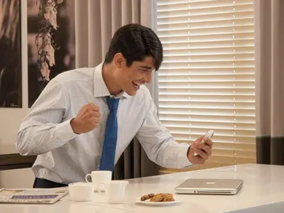 a man in a tie sitting at a table with a plate of food at Seda Bonifacio Global City Manila in Manila