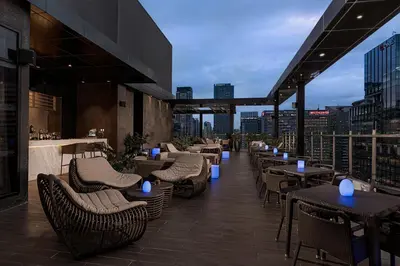 a restaurant with tables and chairs on a rooftop at Seda Bonifacio Global City Manila in Manila
