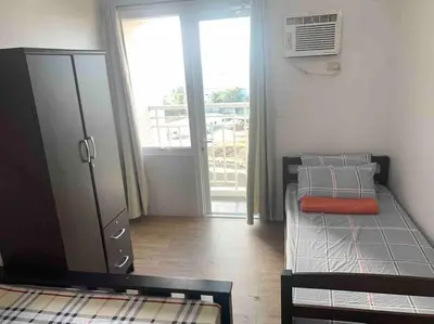 a bedroom with a bunk bed and a door to a balcony at Lovely Spacious Condo With Balcony in Manila