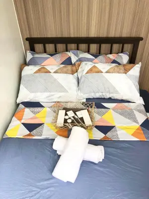 a bed with two rolls of toilet paper on it at Adel's Cosy Place - SMDC Shore 2 Philippines in Manila